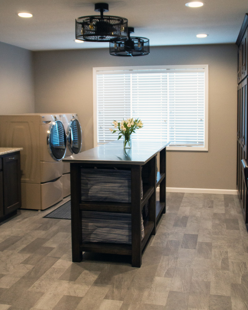 Inspiration for a transitional gray floor utility room remodel with an utility sink, recessed-panel cabinets, dark wood cabinets, granite countertops, gray walls and a side-by-side washer/dryer