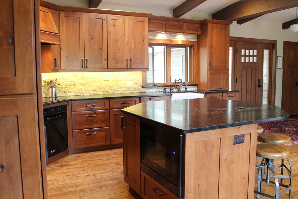 Large transitional l-shaped dark wood floor eat-in kitchen photo in Denver with a farmhouse sink, flat-panel cabinets, dark wood cabinets, granite countertops, beige backsplash, stainless steel appliances and an island