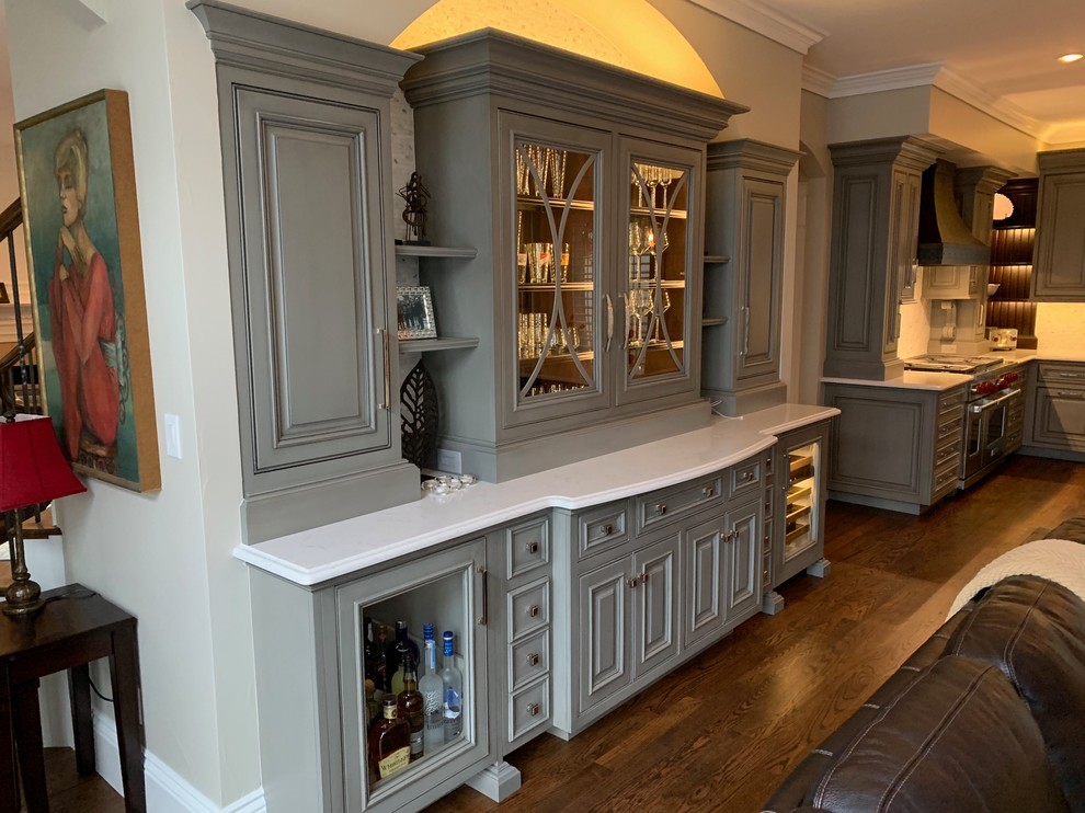 Kitchen - large transitional single-wall medium tone wood floor and brown floor kitchen idea in Denver with a single-bowl sink, beaded inset cabinets, gray cabinets, quartz countertops, mosaic tile backsplash, paneled appliances, an island and beige countertops
