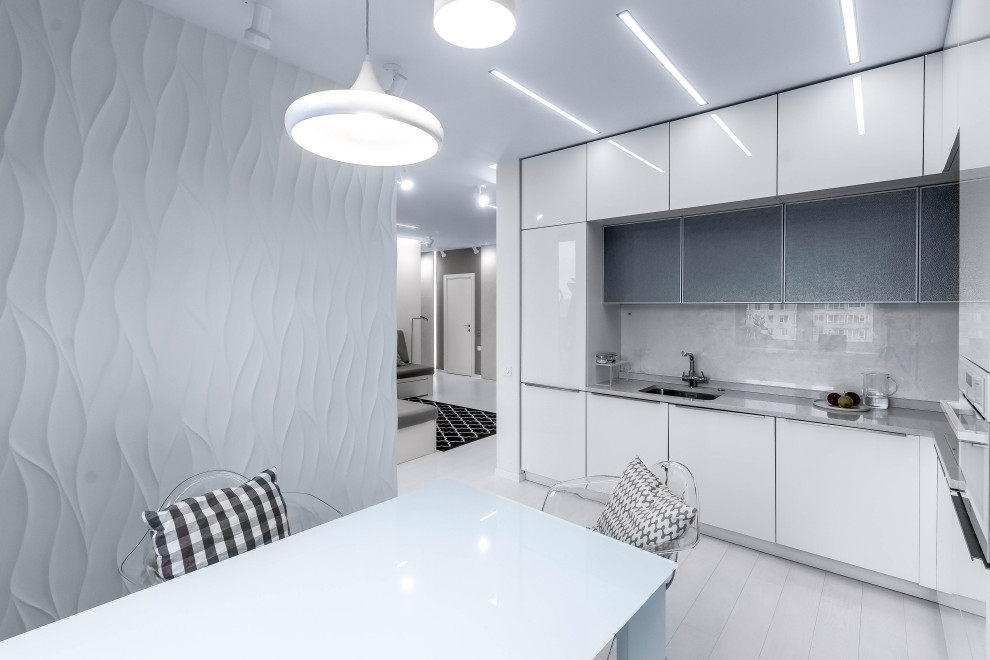 Small contemporary l-shaped kitchen in Saint Petersburg with an undermount sink, flat-panel cabinets, white cabinets, grey splashback, glass sheet splashback, panelled appliances, no island, grey floor and grey benchtop.