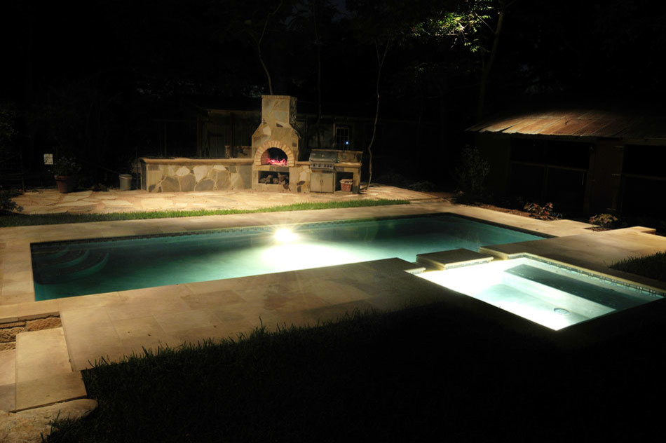 Mid-sized traditional backyard rectangular lap pool in Austin with concrete pavers.