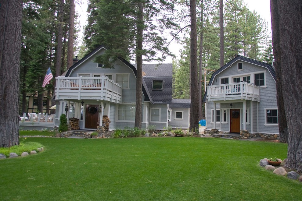 Large country two-storey blue exterior in Sacramento with wood siding.