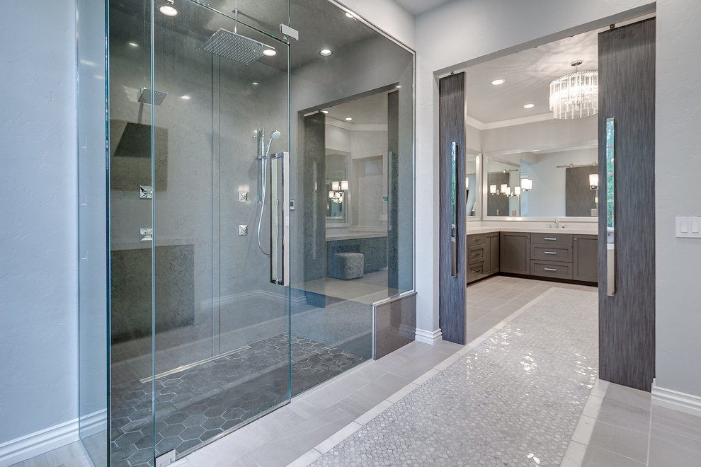 Photo of an expansive contemporary master bathroom in Oklahoma City with beaded inset cabinets, grey cabinets, an alcove shower, grey walls, porcelain floors, grey floor and a hinged shower door.