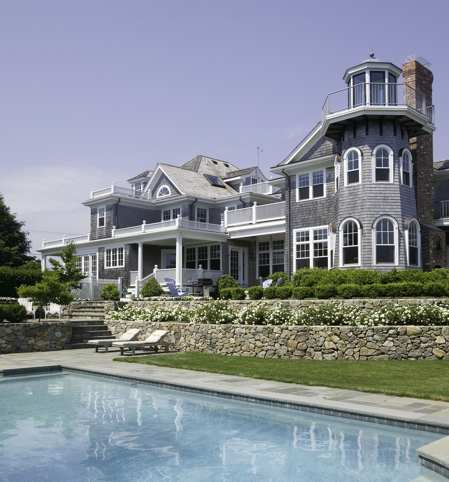This is an example of a beach style grey exterior in Boston.