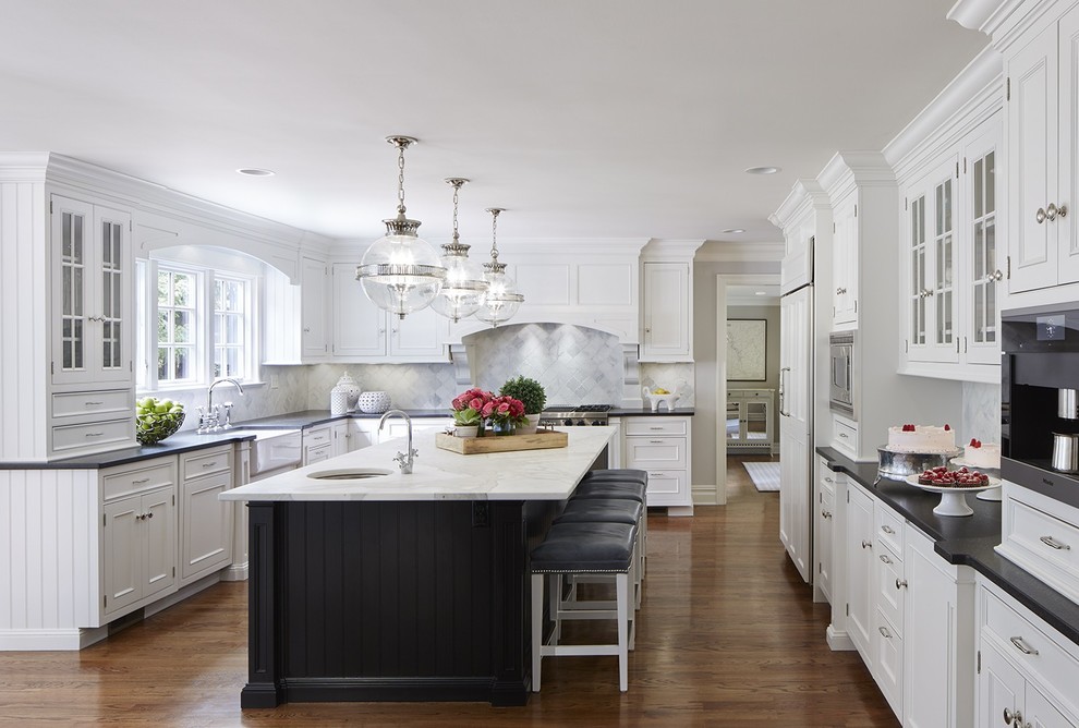 Photo of a large traditional u-shaped kitchen in Sydney with a farmhouse sink, recessed-panel cabinets, marble benchtops, with island and dark hardwood floors.