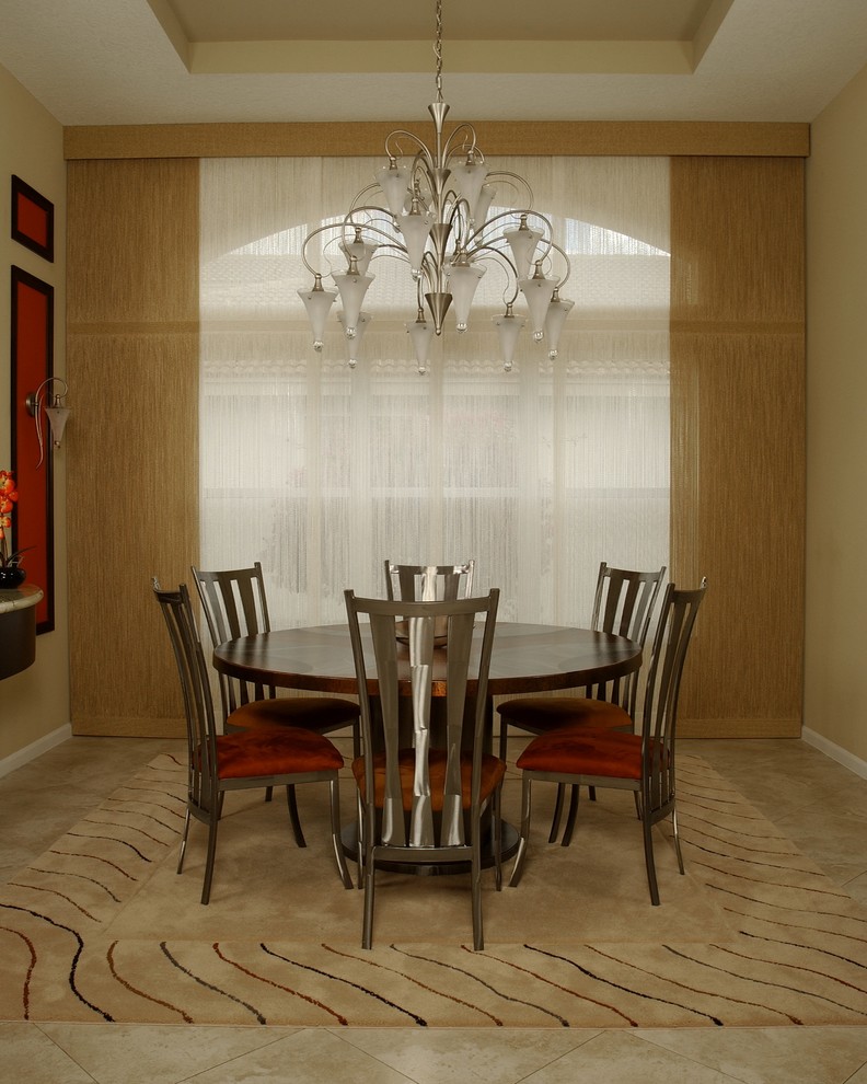 This is an example of a mid-sized traditional separate dining room in Miami with beige walls, carpet, no fireplace and beige floor.