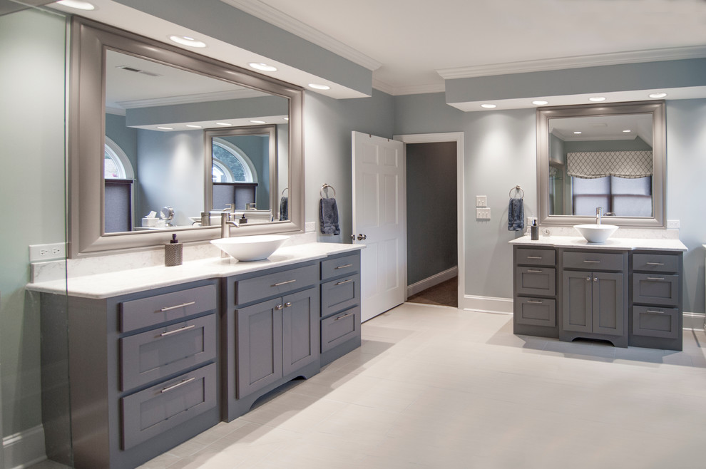 Large transitional master bathroom in Charlotte with a vessel sink, grey cabinets, shaker cabinets, a freestanding tub, a corner shower, beige tile, porcelain tile, blue walls, porcelain floors and engineered quartz benchtops.