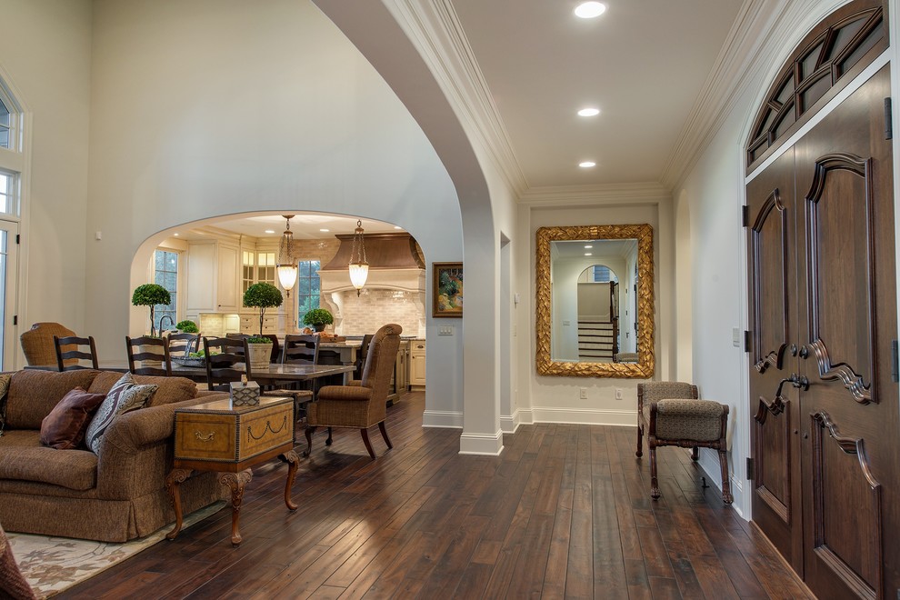 Design ideas for a traditional entry hall in Minneapolis with white walls, dark hardwood floors, a double front door and a dark wood front door.