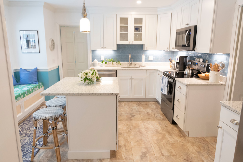 Enclosed kitchen - mid-sized transitional u-shaped beige floor enclosed kitchen idea in Boston with an undermount sink, recessed-panel cabinets, white cabinets, blue backsplash, subway tile backsplash, stainless steel appliances, an island and beige countertops
