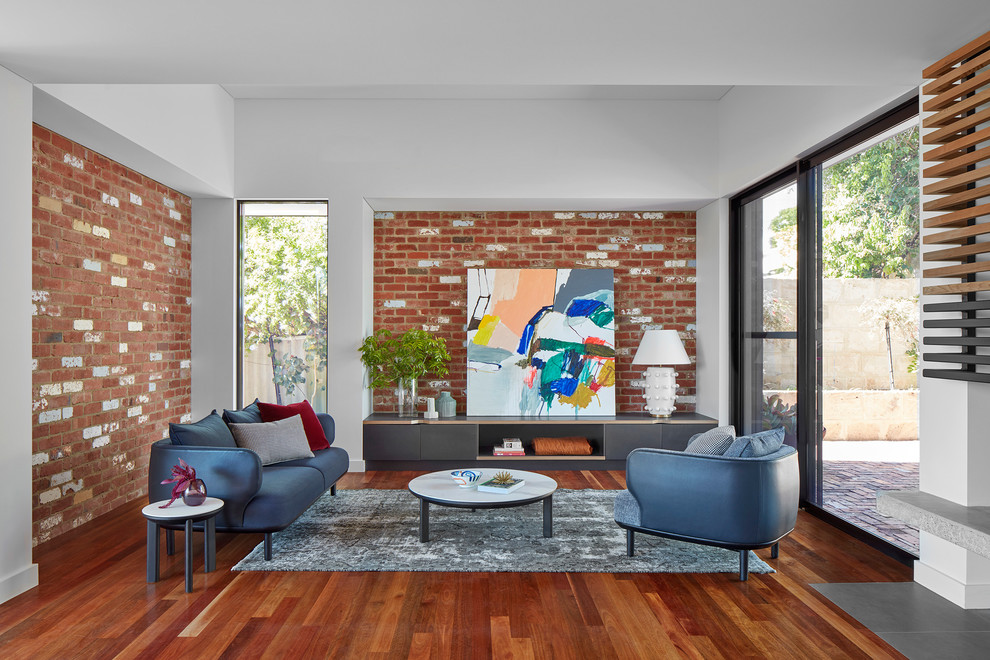 This is an example of a contemporary living room in Perth with white walls, medium hardwood floors and brown floor.