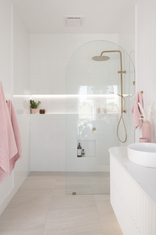 Inspiration for a beach style bathroom in Hobart with flat-panel cabinets, white cabinets, a curbless shower, white tile, white walls, a vessel sink, grey floor, an open shower, white benchtops, a single vanity and a floating vanity.