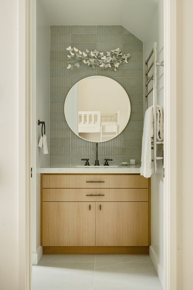 Inspiration for a modern gray tile gray floor powder room remodel in Los Angeles with flat-panel cabinets, light wood cabinets, white walls, an undermount sink, white countertops and a built-in vanity