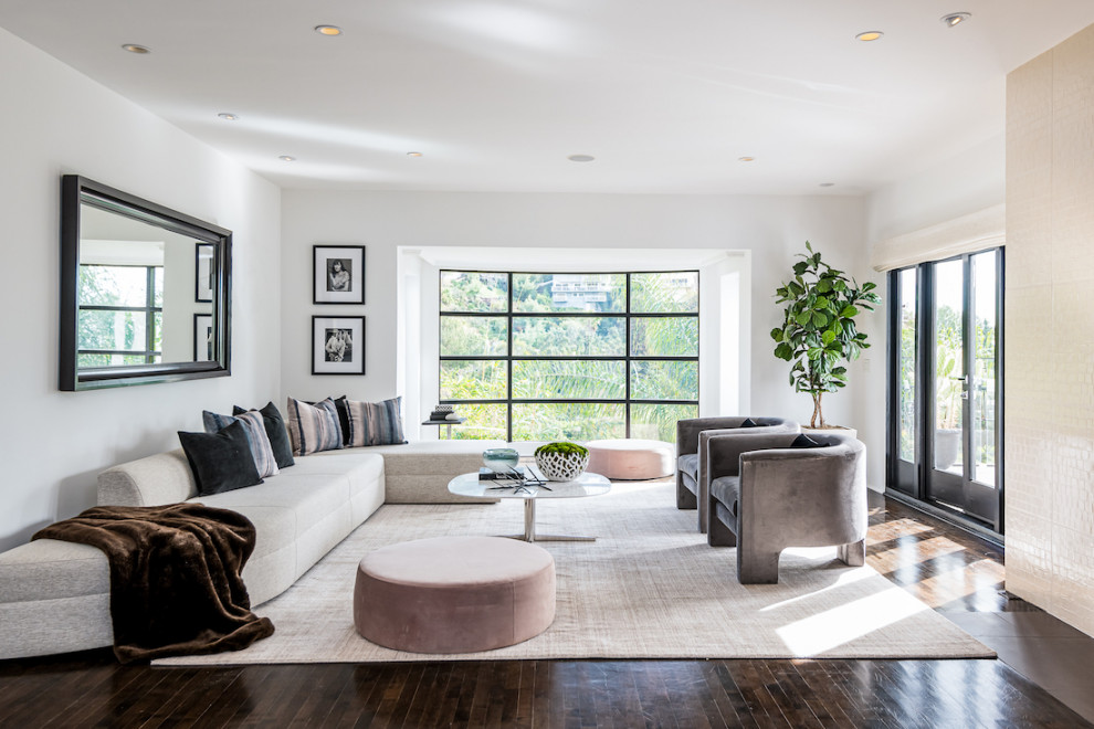 Inspiration for a contemporary living room in Los Angeles with white walls, dark hardwood floors and brown floor.