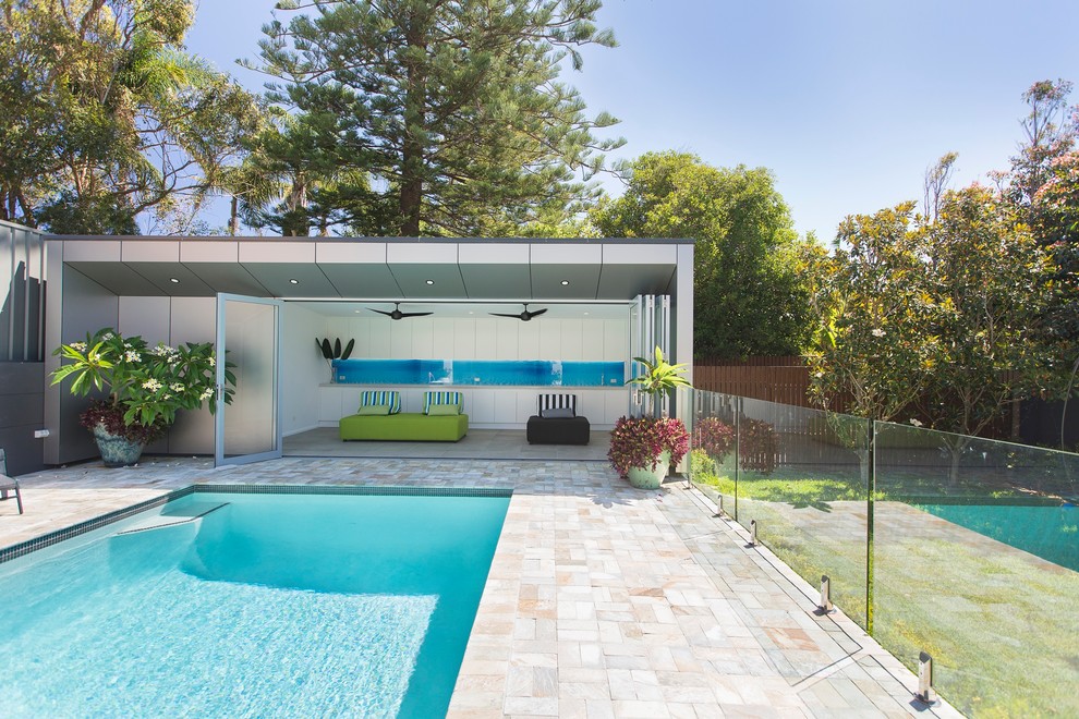 Design ideas for a mid-sized contemporary backyard rectangular lap pool in Newcastle - Maitland with a pool house and tile.