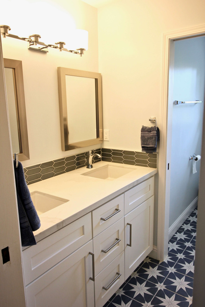 Inspiration for a mid-sized modern 3/4 bathroom in San Francisco with shaker cabinets, blue cabinets, an undermount tub, a corner shower, a two-piece toilet, white tile, porcelain tile, white walls, dark hardwood floors, an undermount sink, quartzite benchtops, brown floor, a hinged shower door and white benchtops.