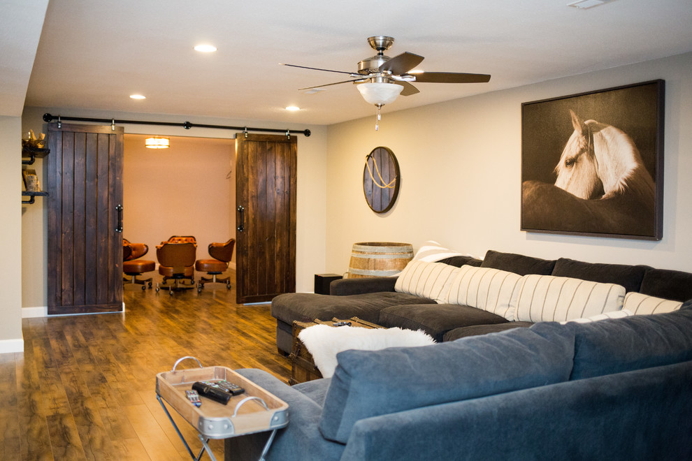 Example of a mid-sized mountain style underground medium tone wood floor basement design in St Louis with beige walls and no fireplace