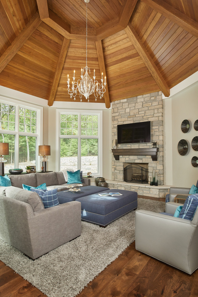 Design ideas for a large traditional sunroom in Grand Rapids with dark hardwood floors, a standard fireplace, a stone fireplace surround and brown floor.