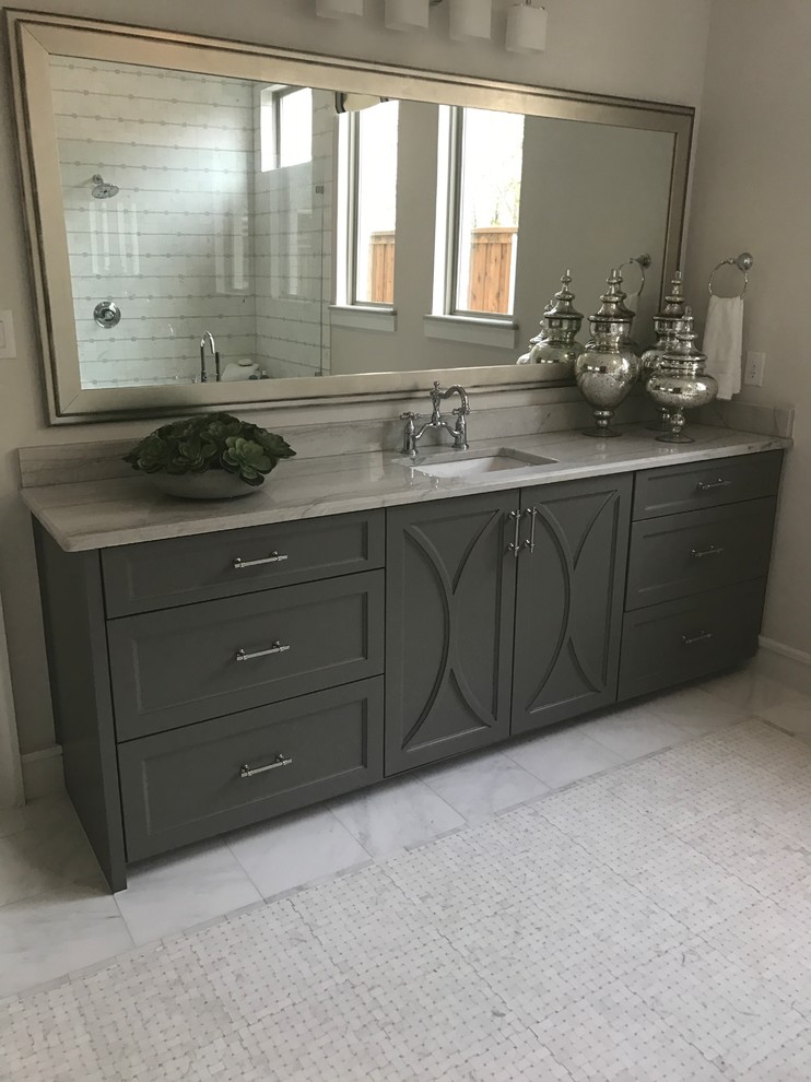 Inspiration for a mid-sized transitional 3/4 bathroom in Dallas with recessed-panel cabinets, grey cabinets, a corner shower, white tile, grey walls, marble floors, an undermount sink, marble benchtops, grey floor, a hinged shower door and grey benchtops.