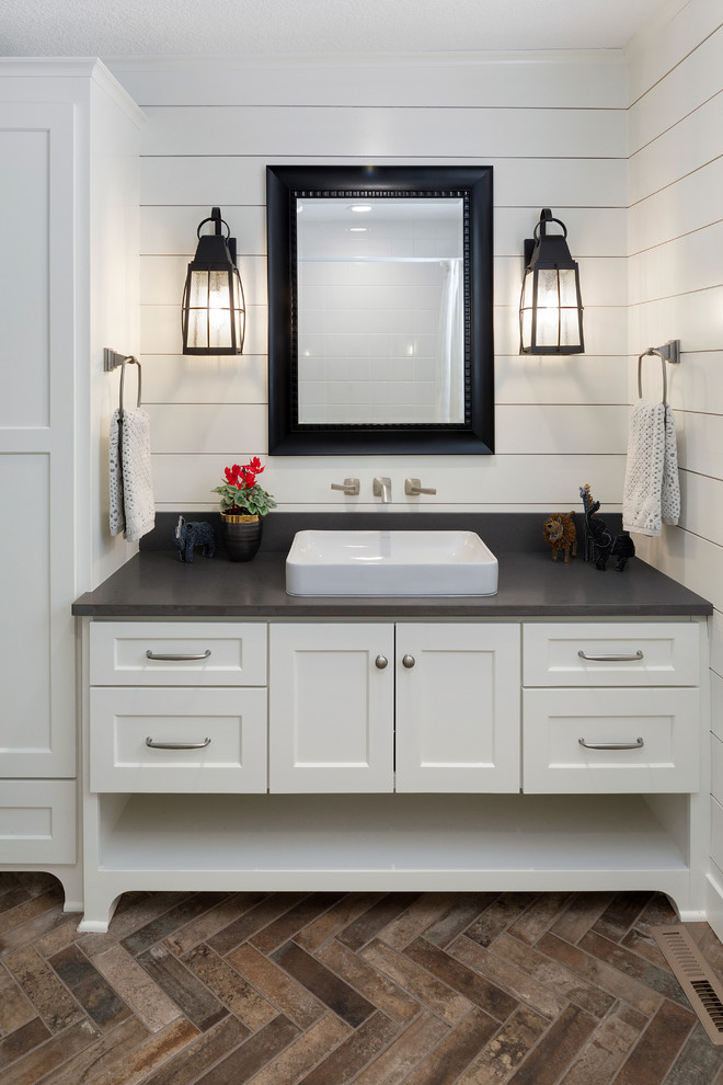 Mid-sized transitional 3/4 bathroom in Minneapolis with shaker cabinets, white cabinets, white tile, white walls, dark hardwood floors, a drop-in sink, solid surface benchtops and multi-coloured floor.