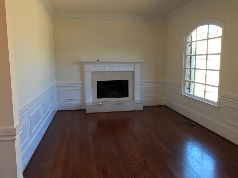 Photo of a mid-sized traditional formal enclosed living room in Atlanta with yellow walls, dark hardwood floors, a standard fireplace, a stone fireplace surround and no tv.