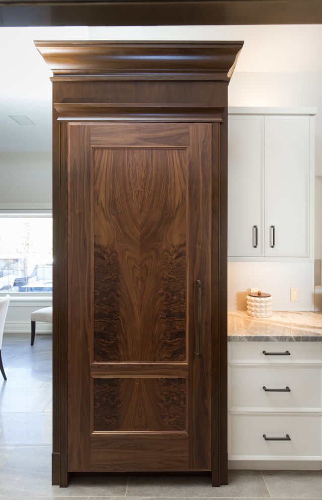 Example of a transitional home design design in Calgary