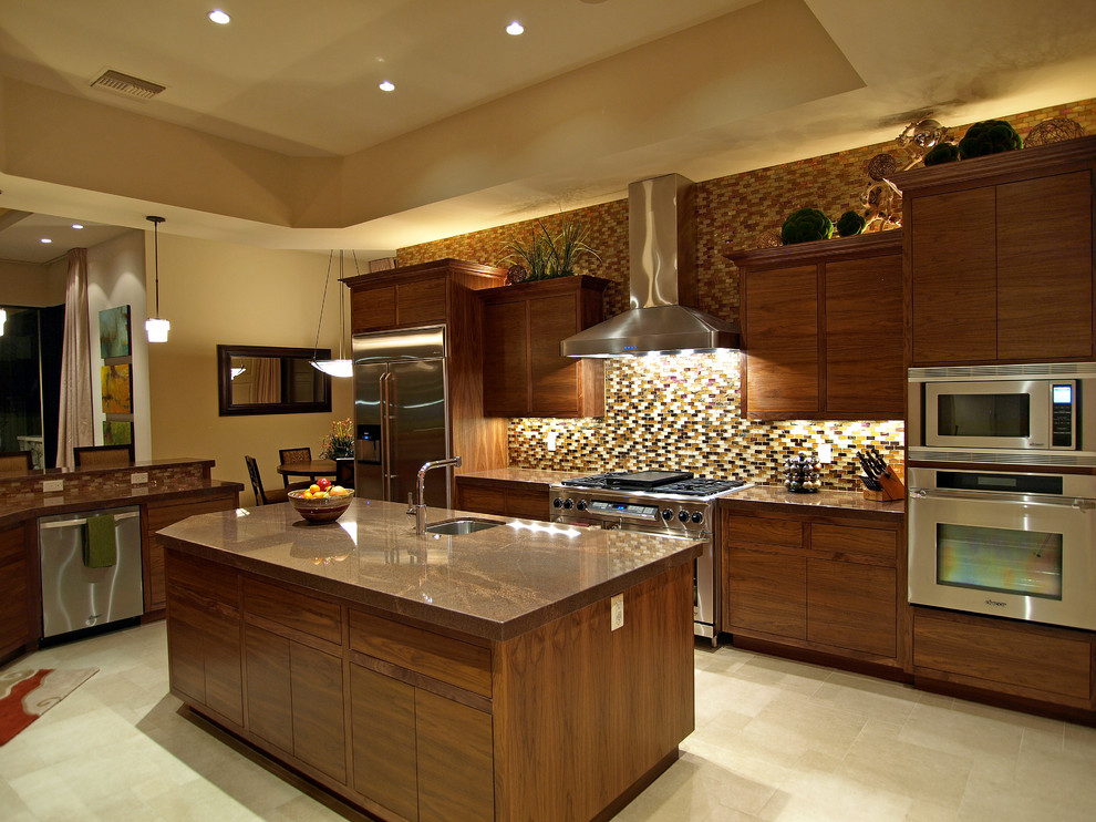 Photo of a large transitional u-shaped open plan kitchen in Las Vegas with an undermount sink, flat-panel cabinets, brown cabinets, granite benchtops, multi-coloured splashback, glass tile splashback, stainless steel appliances, porcelain floors and with island.