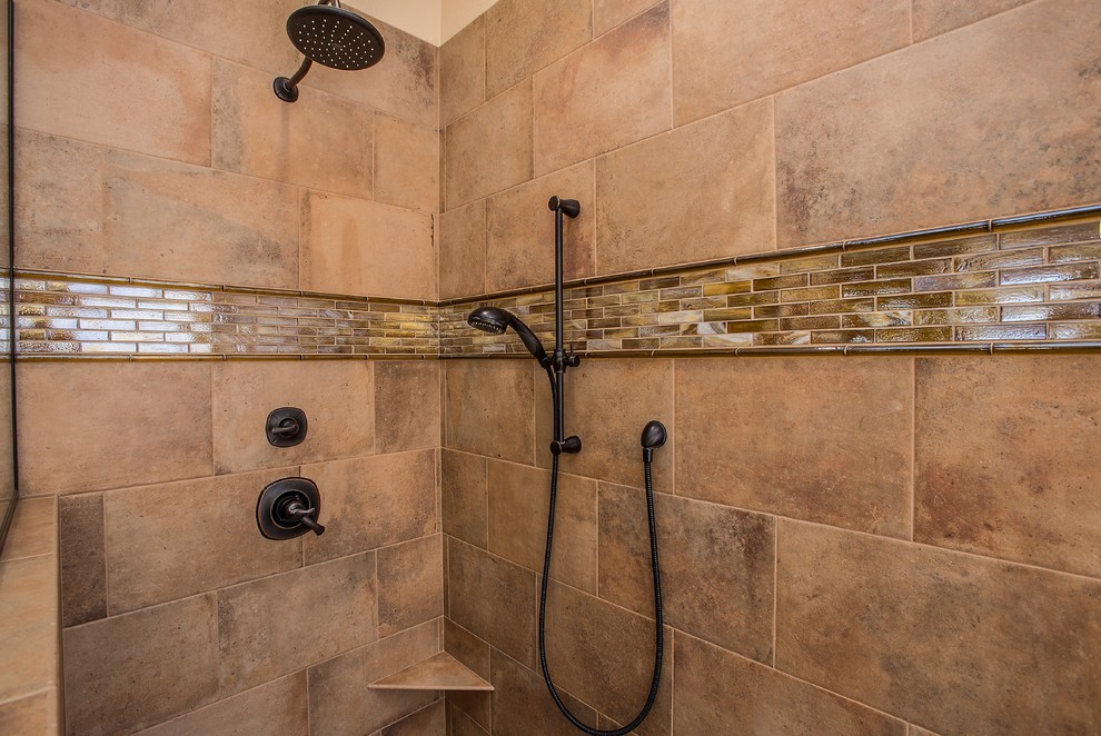 Inspiration for a large modern master bathroom in Phoenix with a drop-in sink, raised-panel cabinets, medium wood cabinets, granite benchtops, an open shower, brown tile, ceramic tile, beige walls and ceramic floors.