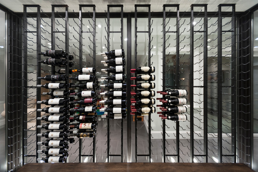 Photo of a large transitional wine cellar in Vancouver with storage racks.