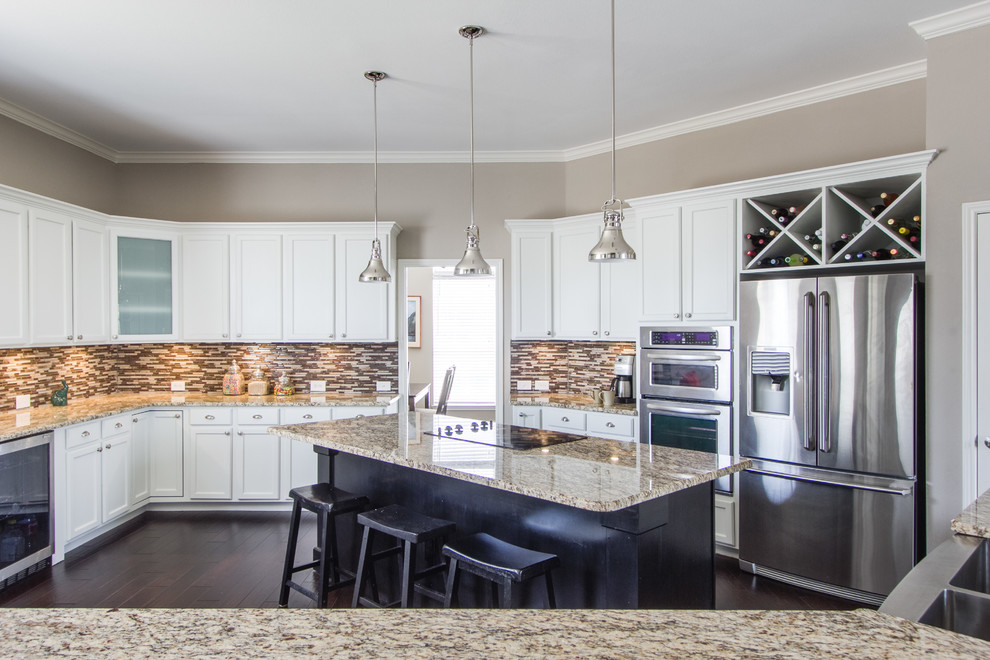 Inspiration for a mid-sized transitional eat-in kitchen in Dallas with a double-bowl sink, shaker cabinets, white cabinets, granite benchtops, stainless steel appliances, dark hardwood floors, with island and multi-coloured splashback.