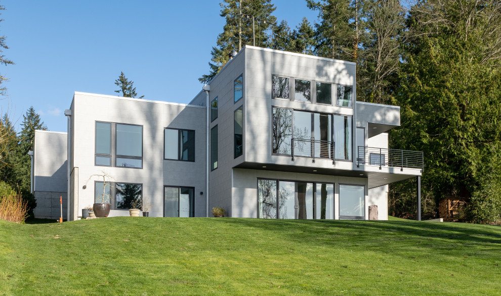 Mid-sized modern white two-story concrete fiberboard exterior home idea in Seattle with a white roof