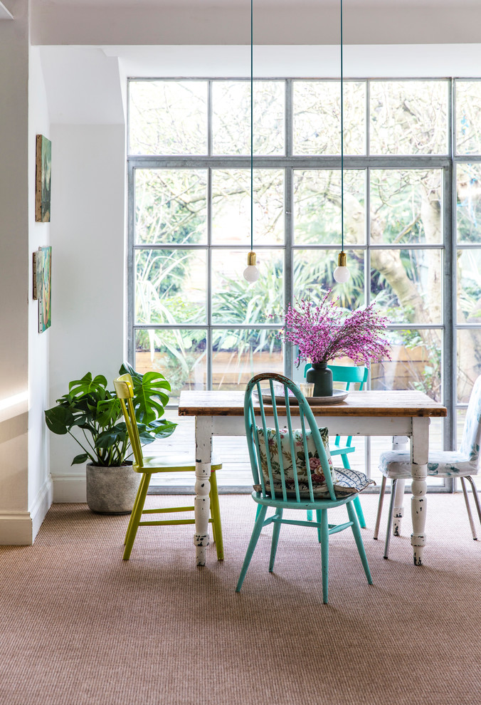 Inspiration for an eclectic dining room in Hampshire with white walls and carpet.