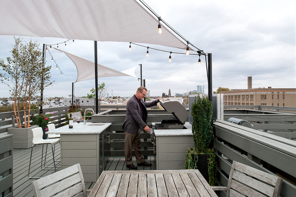 Mid-sized contemporary rooftop deck in Philadelphia with an outdoor kitchen and an awning.
