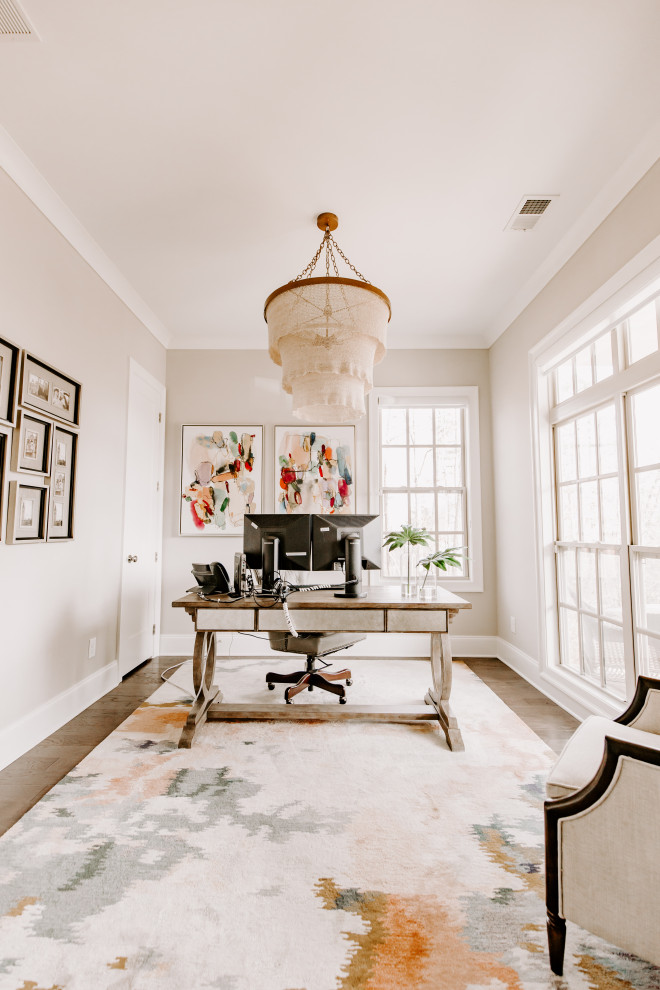 Inspiration for a small transitional study room in Atlanta with beige walls, dark hardwood floors, a freestanding desk, brown floor and no fireplace.