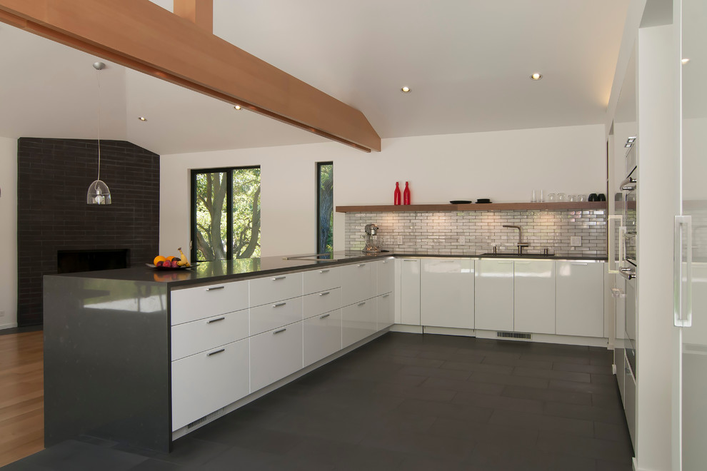 Photo of a contemporary u-shaped kitchen in San Francisco with flat-panel cabinets and white cabinets.
