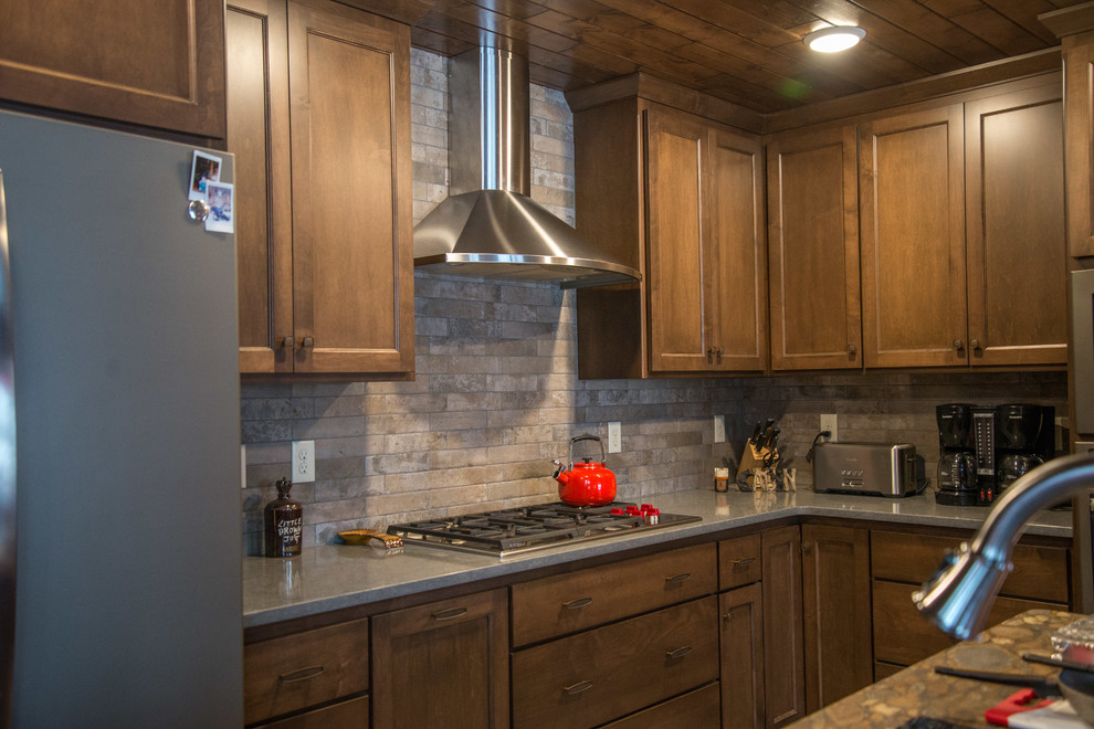 Kitchen - rustic vinyl floor and brown floor kitchen idea with medium tone wood cabinets, beige backsplash, stainless steel appliances and ceramic backsplash