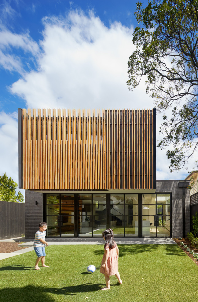 Design ideas for a mid-sized contemporary two-storey multi-coloured house exterior in Melbourne with mixed siding and a flat roof.
