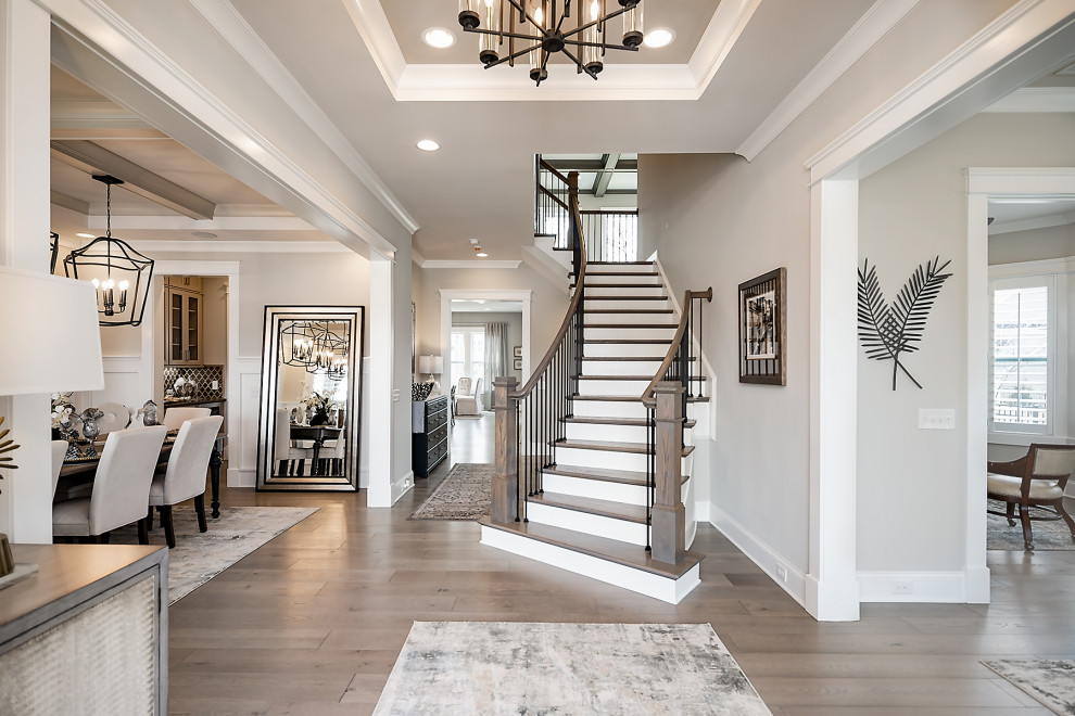 Inspiration for a mid-sized foyer in Charlotte with grey walls, light hardwood floors, a white front door and recessed.