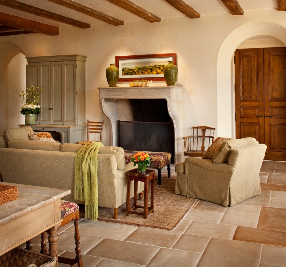 Mid-sized mediterranean open concept living room in Other with beige walls, a standard fireplace, no tv, ceramic floors and a concrete fireplace surround.