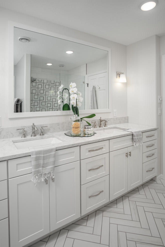 Photo of a large transitional master bathroom in Other with shaker cabinets, white cabinets, an open shower, a two-piece toilet, white tile, marble, grey walls, porcelain floors, an undermount sink, engineered quartz benchtops, white floor, a hinged shower door, white benchtops, a niche, a double vanity and a built-in vanity.