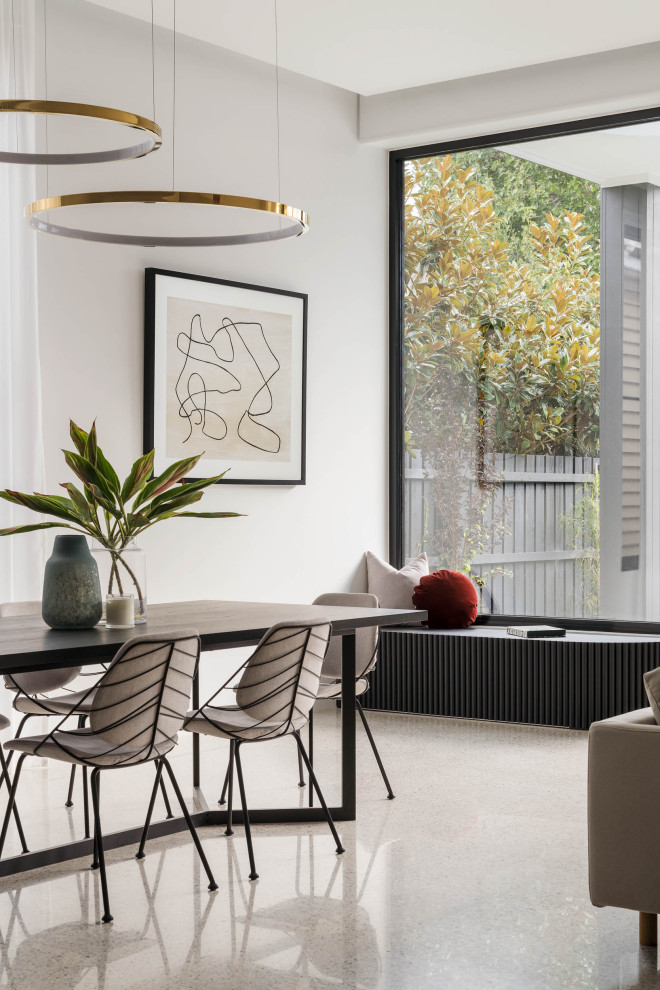 Inspiration for a large contemporary open plan dining room in Melbourne with white walls, concrete flooring and white floors.
