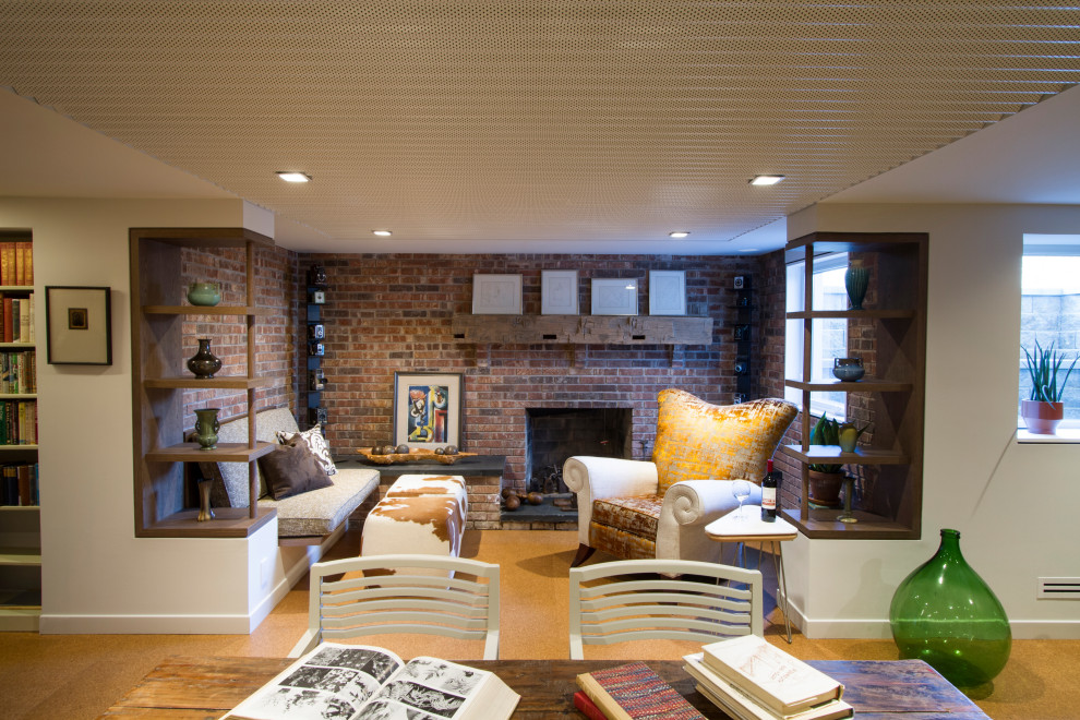 Inspiration for a mid-sized midcentury open concept living room in Philadelphia with a library, white walls, cork floors, a standard fireplace, a brick fireplace surround, beige floor, coffered and brick walls.