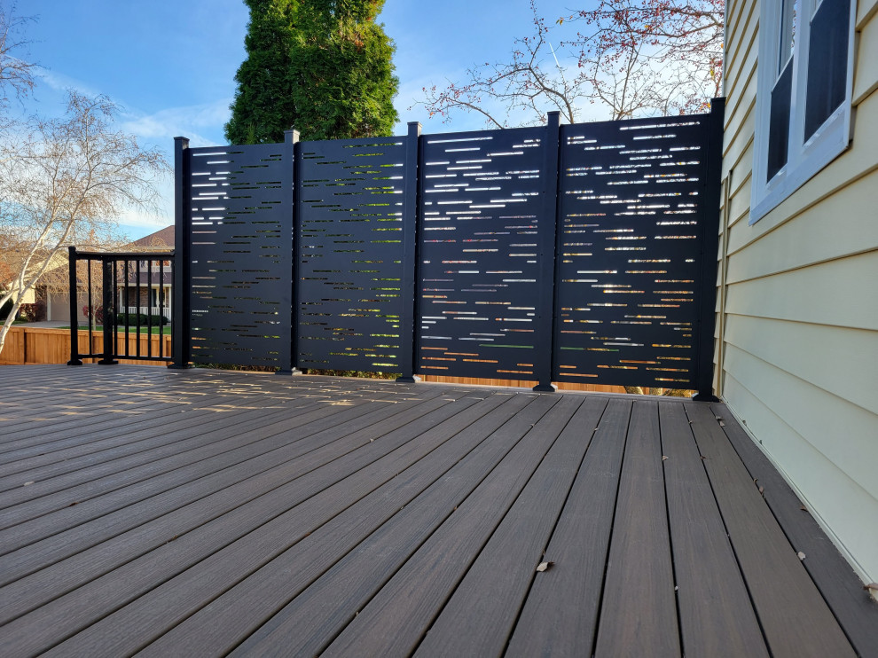 Inspiration for a mid-sized backyard and ground level deck in Other with with privacy feature, no cover and metal railing.