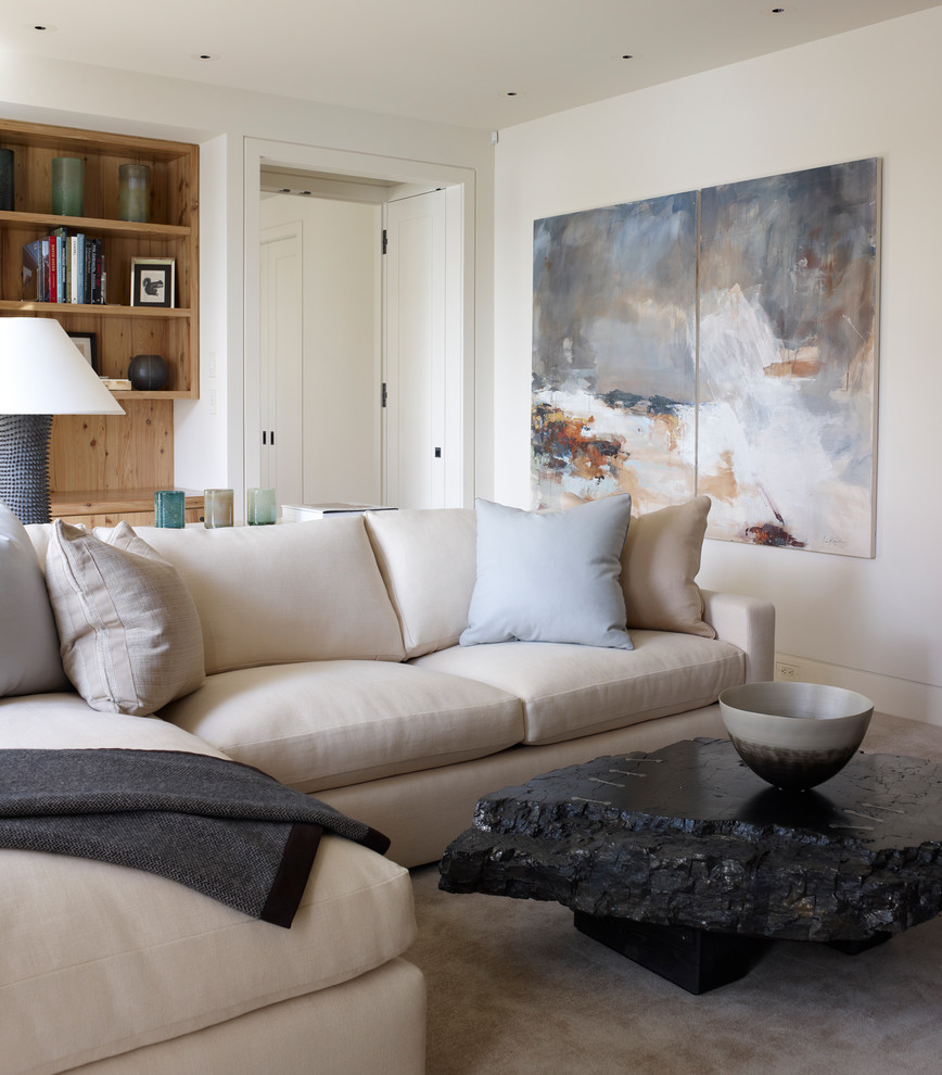 This is an example of a contemporary family room in Grand Rapids with white walls and carpet.