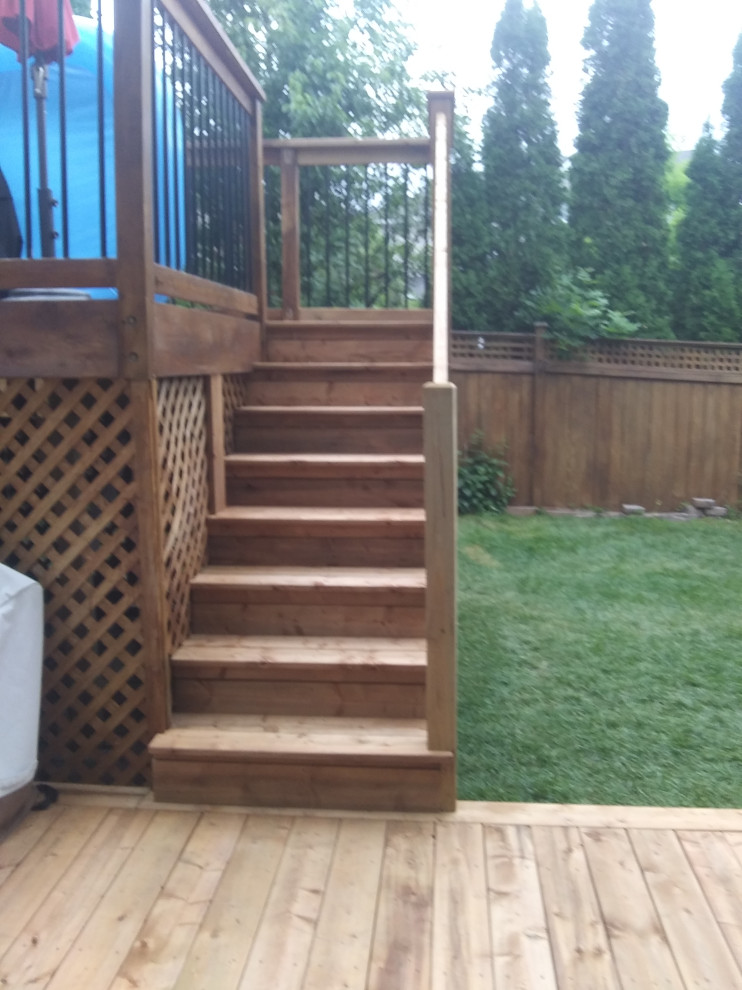 Photo of a medium sized traditional back private and ground level wood railing terrace in Ottawa.