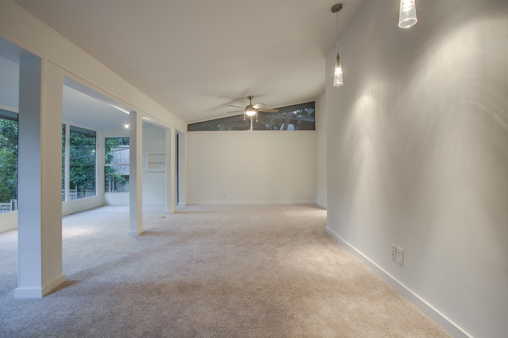 This is an example of an expansive midcentury master bedroom in Dallas with white walls and carpet.