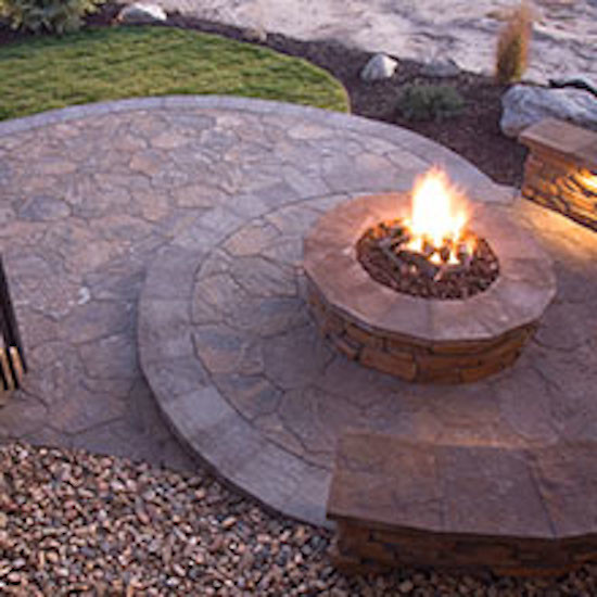 Inspiration for a backyard garden in Portland with a fire feature and natural stone pavers.