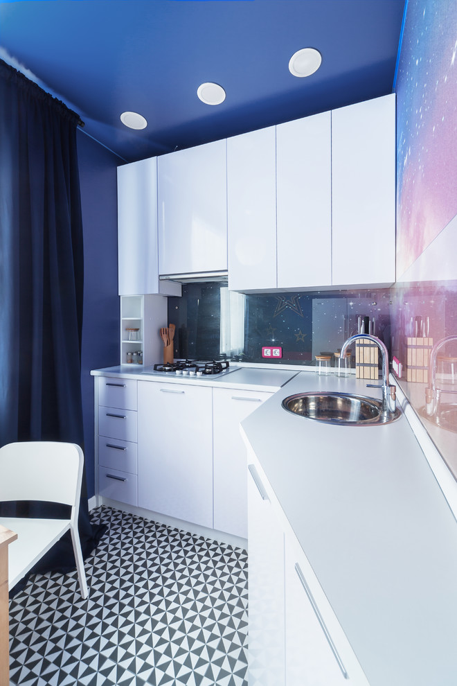 Inspiration for a small contemporary l-shaped kitchen in Yekaterinburg with porcelain floors, no island, a drop-in sink, flat-panel cabinets, white cabinets, multi-coloured splashback, glass tile splashback and multi-coloured floor.