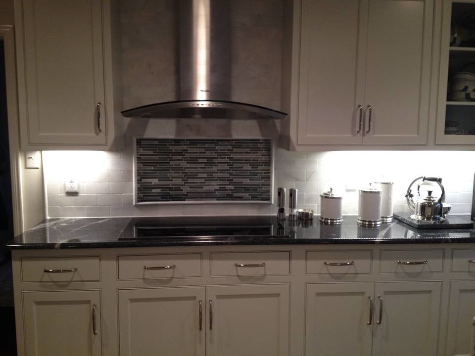 Inspiration for a large transitional l-shaped medium tone wood floor kitchen remodel with beaded inset cabinets, white cabinets, white backsplash, subway tile backsplash, a farmhouse sink, stainless steel appliances and an island