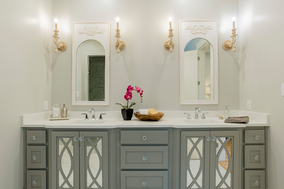 Inspiration for a transitional bathroom remodel with shaker cabinets, gray cabinets, beige walls, an undermount sink, quartzite countertops and white countertops