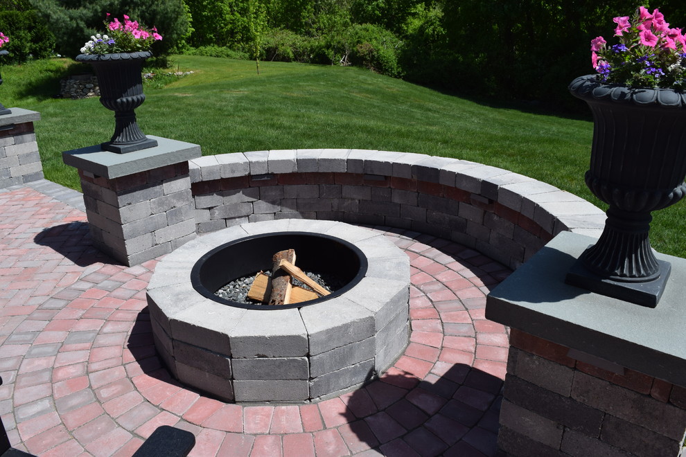 Inspiration for a mid-sized traditional backyard patio in Providence with a fire feature, concrete pavers and no cover.
